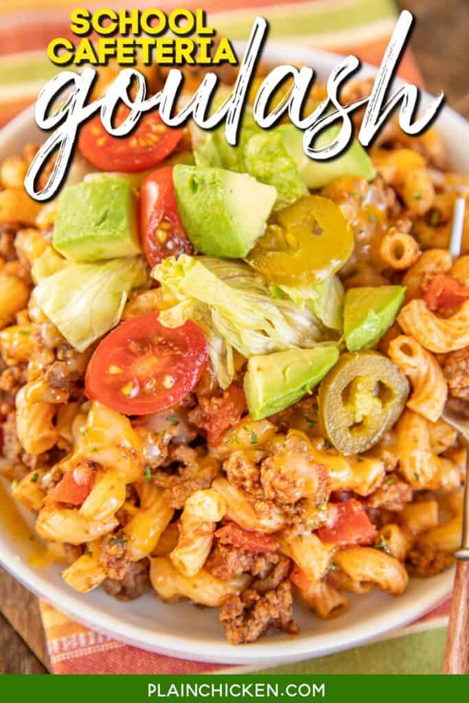 plate of macaroni beef topped with tomatoes and avocado