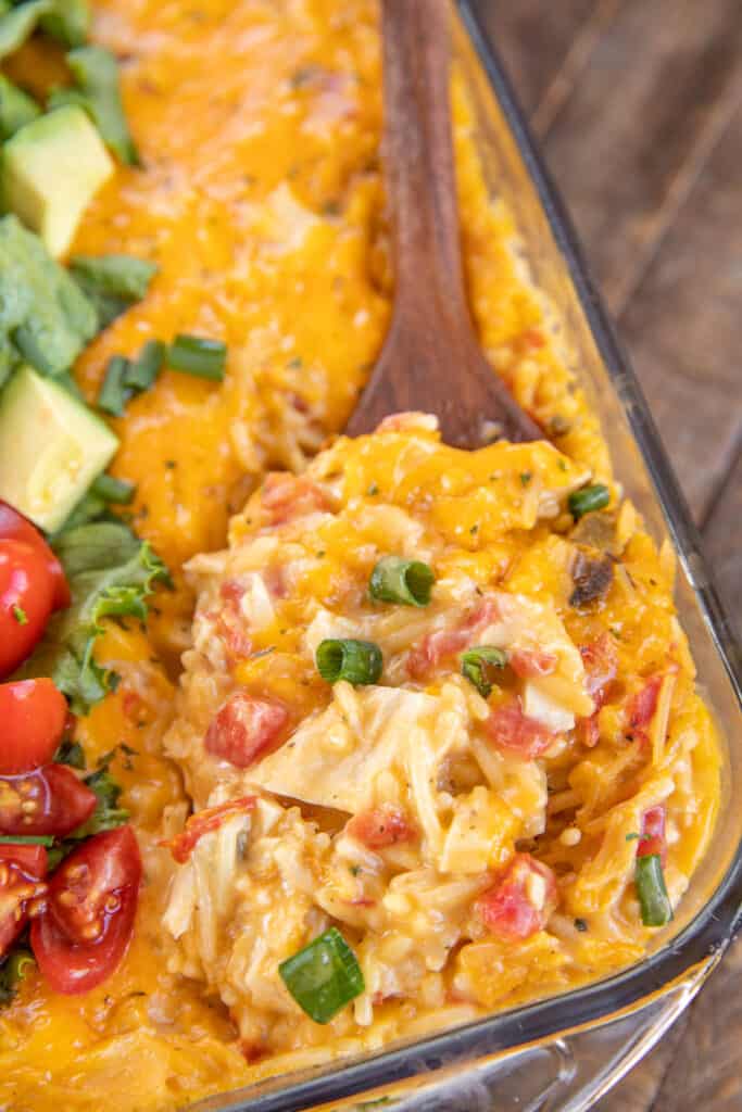 cheesy king ranch chicken and rice casserole topped with lettuce and tomatoes