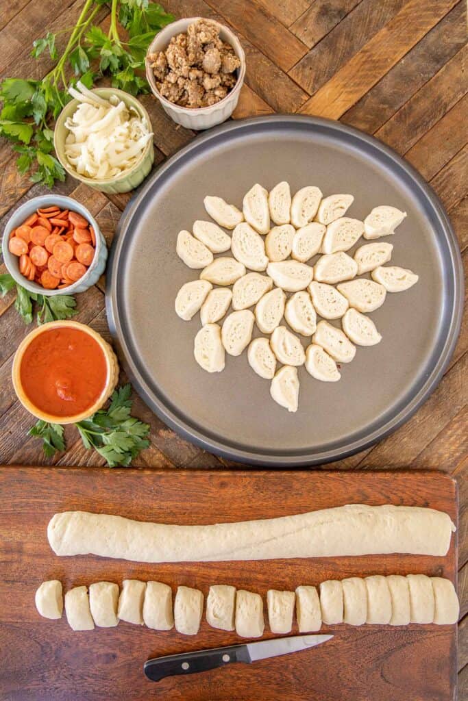 pieces of pizza dough on a pizza pan