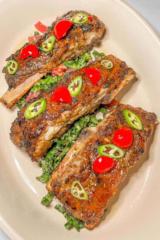 plate of ribs topped with cherry peppers and jalapenos