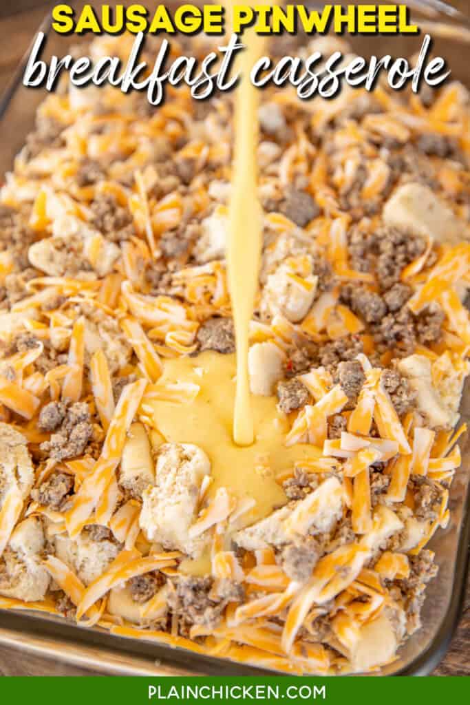 pouring egg and milk over sausage pinwheels and cheese in baking dish