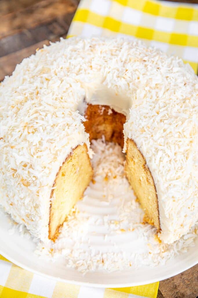 sliced white chocolate coconut cake on a plate