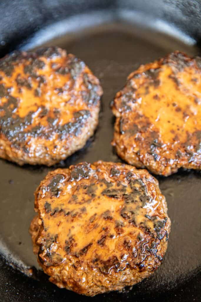 burgers in a cast iron skillet