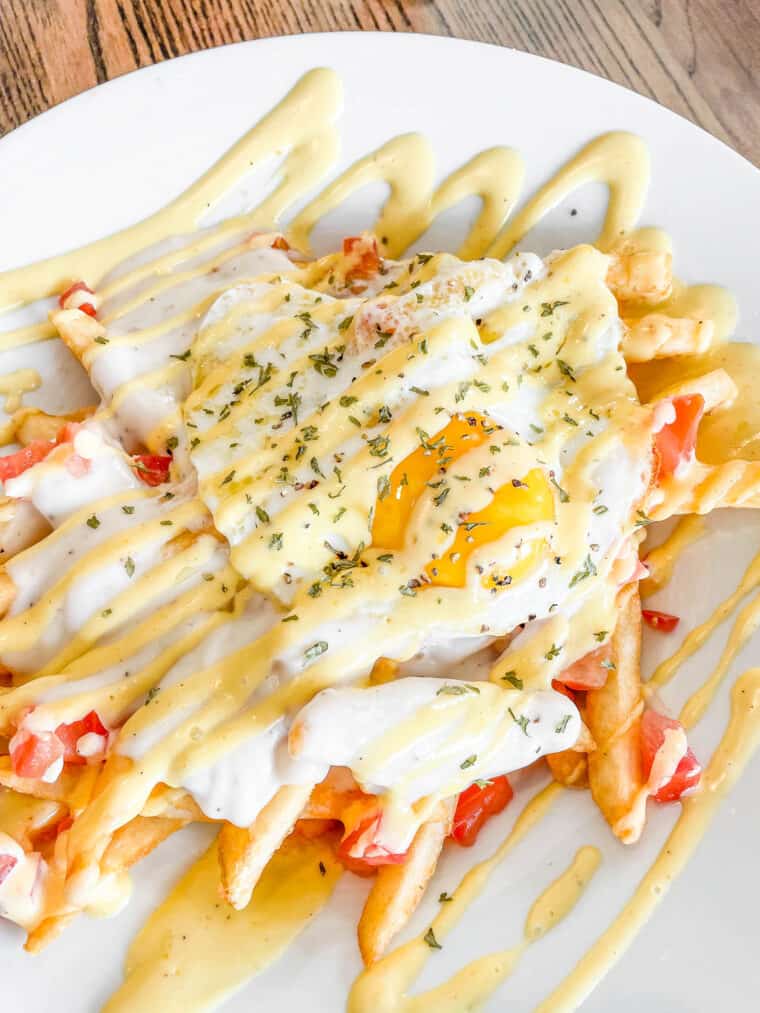 plate of fries topped with an egg