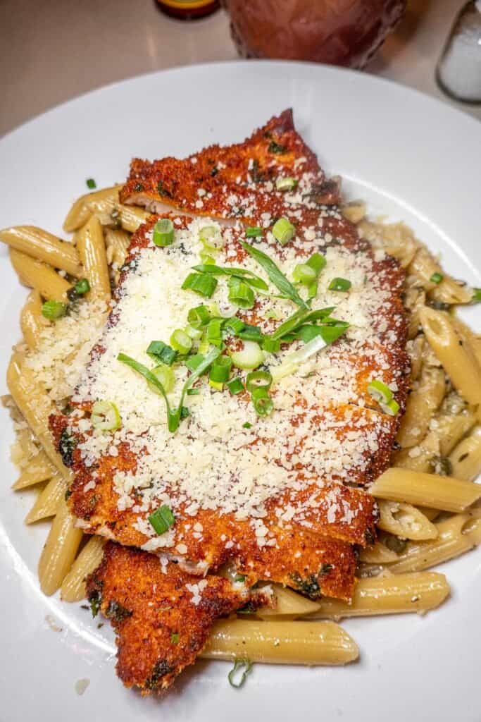 pan fried chicken over pasta