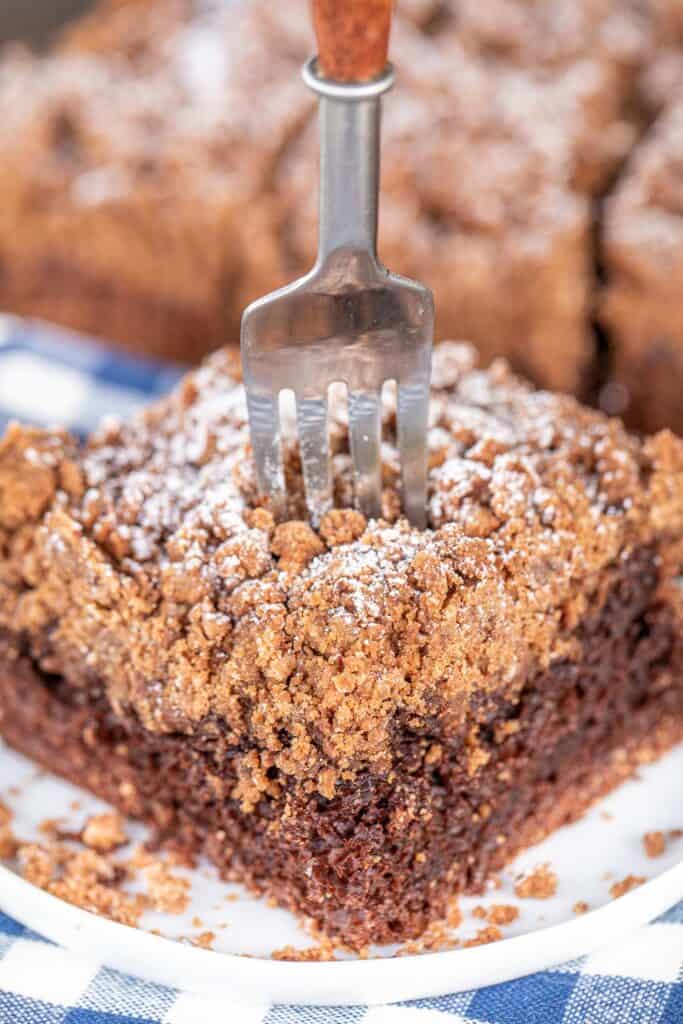 fork going into a slice of chocolate crumb cake