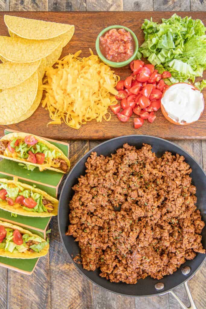 skillet of ground beef taco meat with taco toppings