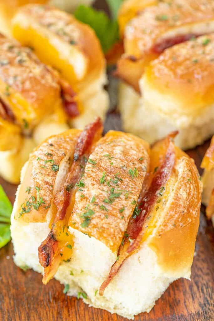 cheese and bacon stuffed hawaiian rolls on a platter