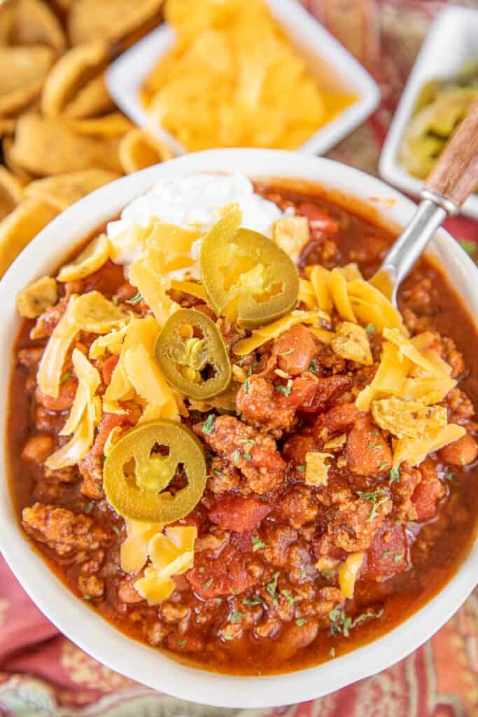 bowl of chili topped with cheese and jalapenos