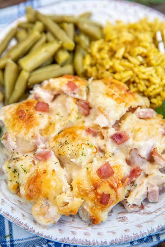 plate of chicken cordon bleu bubble up with rice and green beans