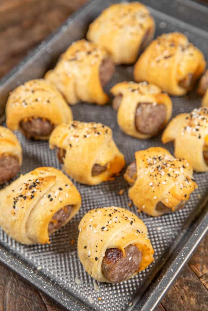 baking sheet of baked brats in crescent rolls