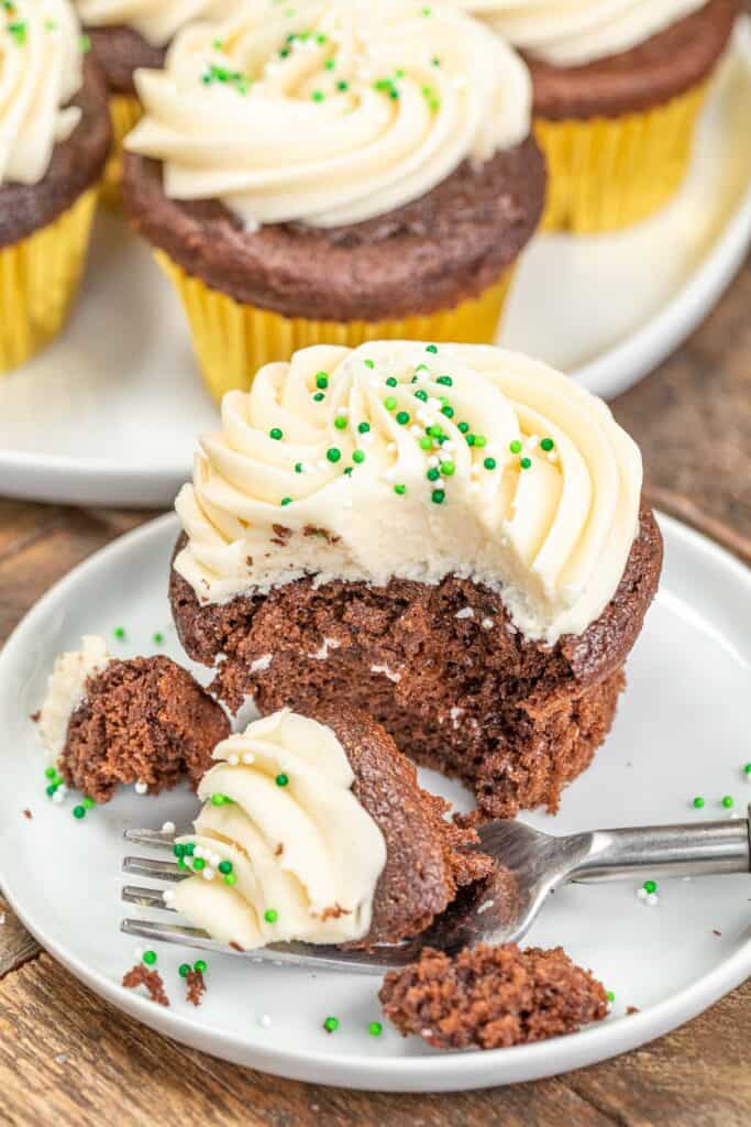 cutting into a frosted guinness chocolate cupcake with a fork