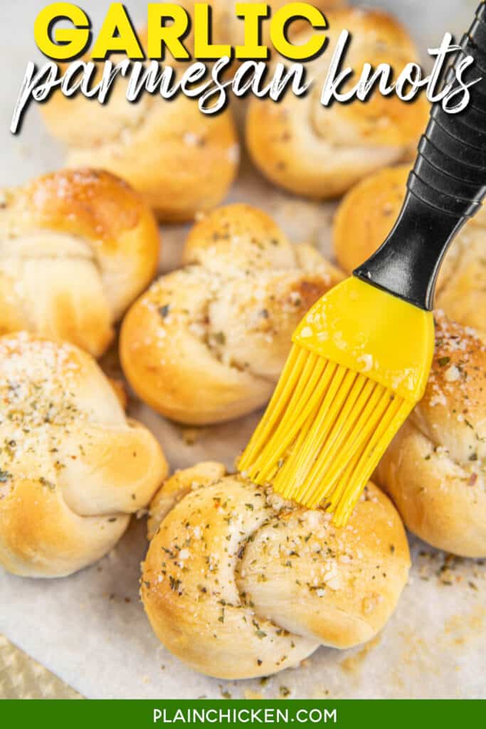 brushing garlic knots with butter with text overlay