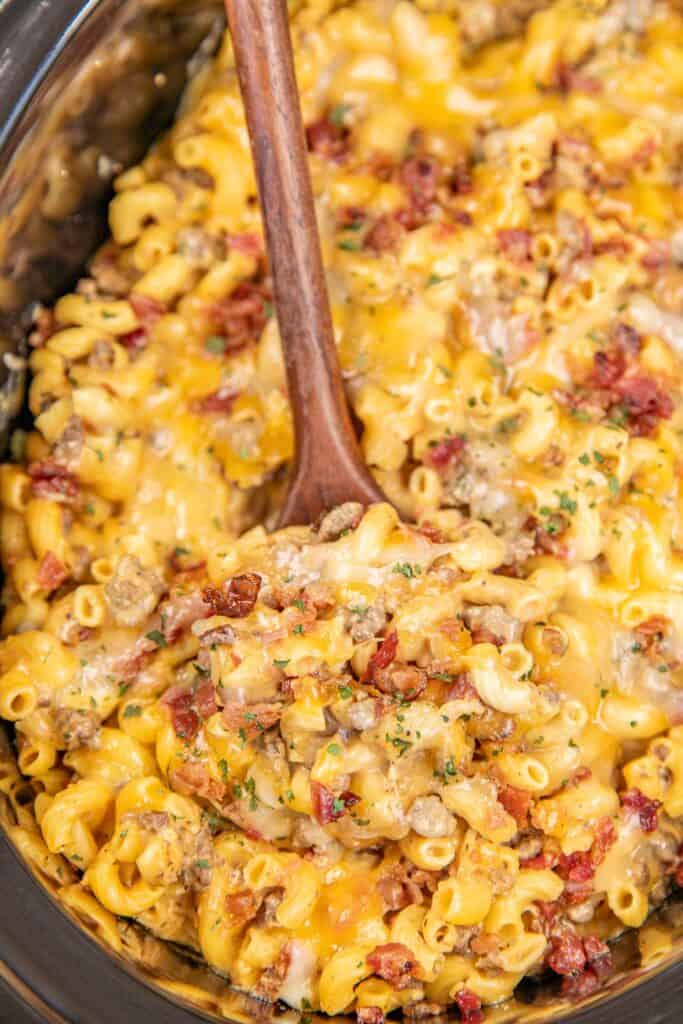 scooping bacon cheeseburger mac and cheese from crockpot