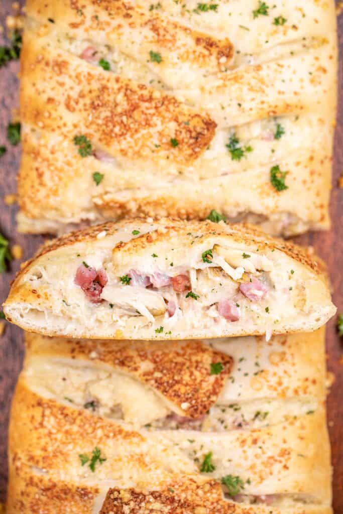 slice of chicken and ham pizza braid on a platter