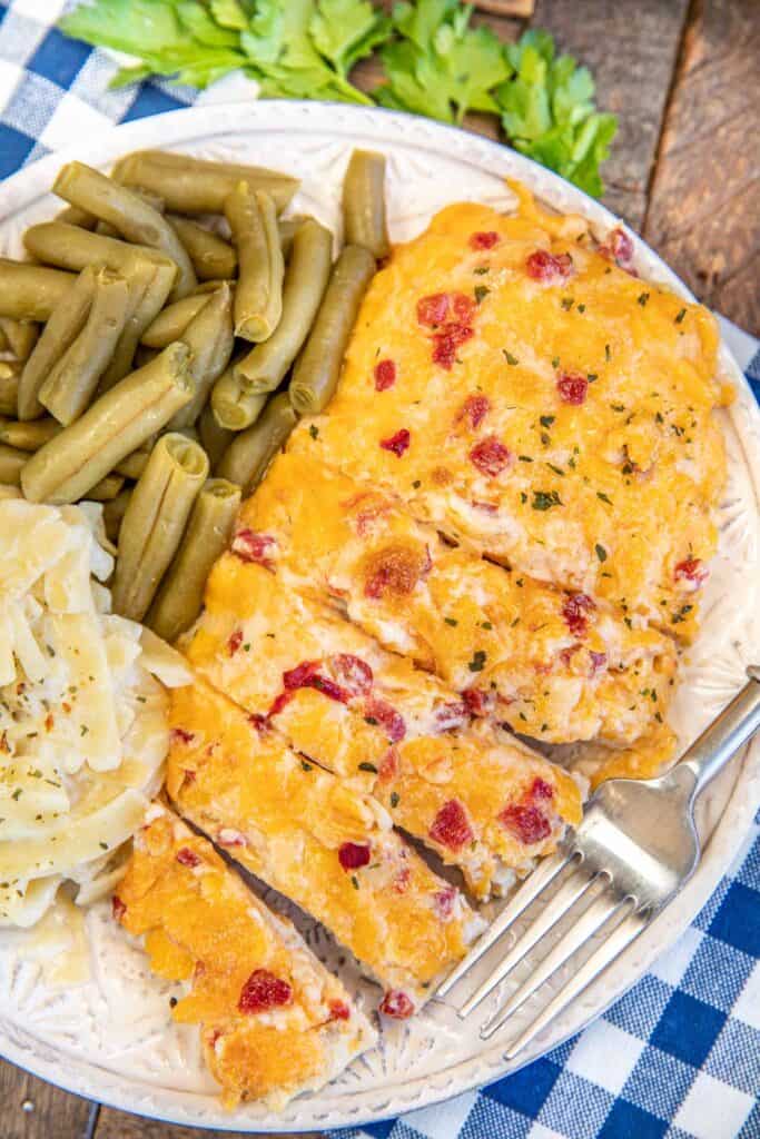 plate of sliced chicken topped with pimento cheese