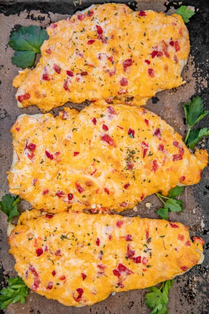 pimento cheese baked chicken on a baking sheet