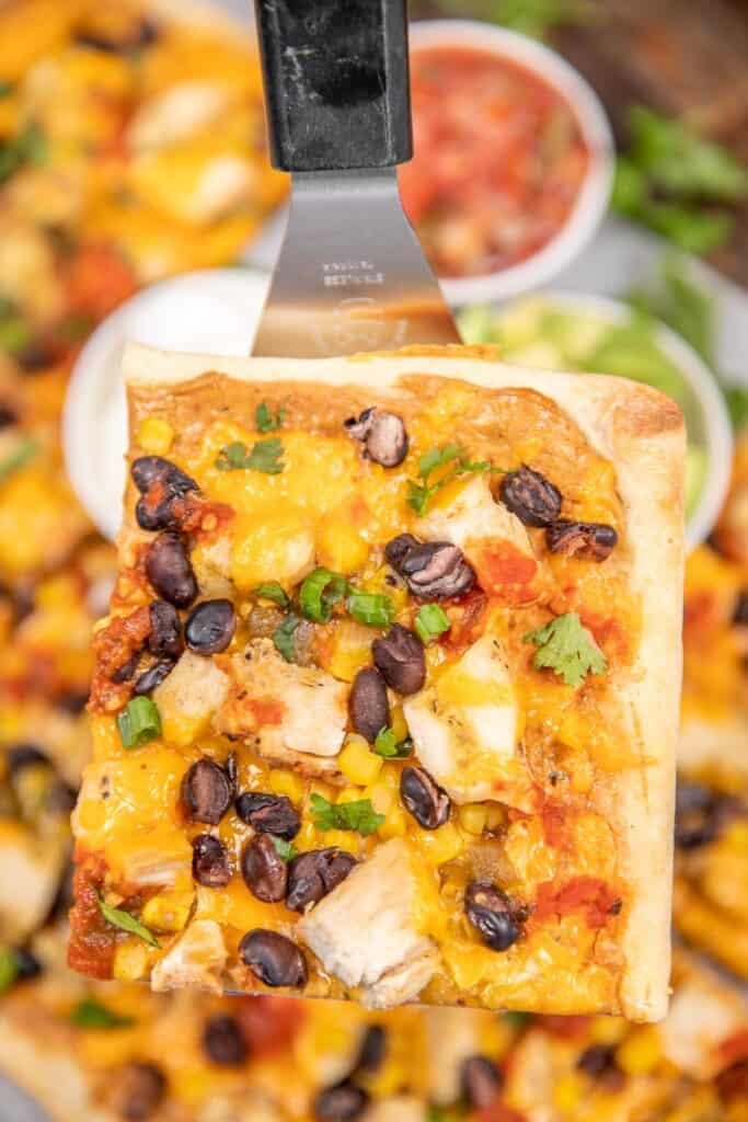 mexican pizza with chicken on a spatula