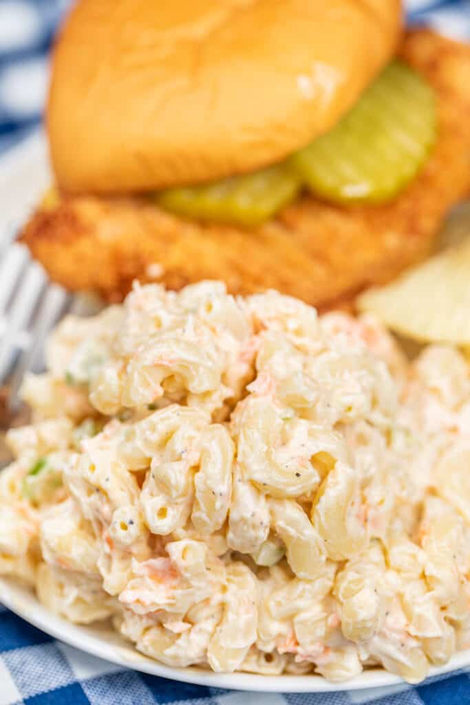plate of macaroni salad with a chicken sandwich