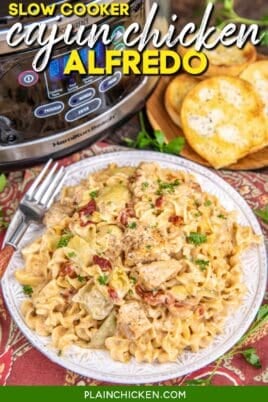 plate of cajun chicken alfredo with slow cooker in the background with text overlay