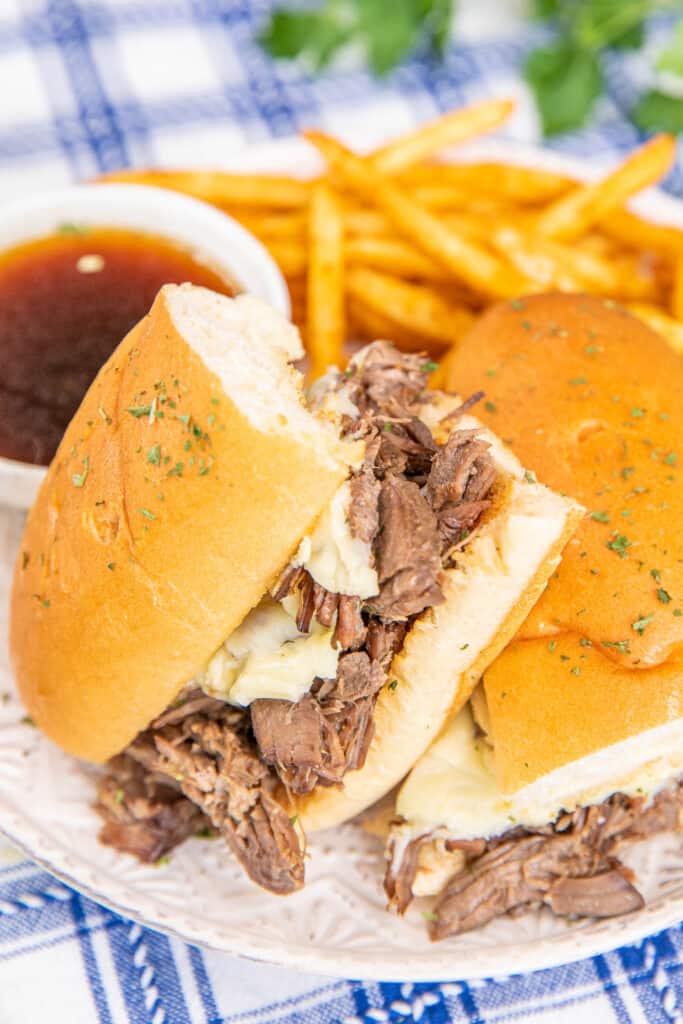 french dip sandwich on a plate with au jus