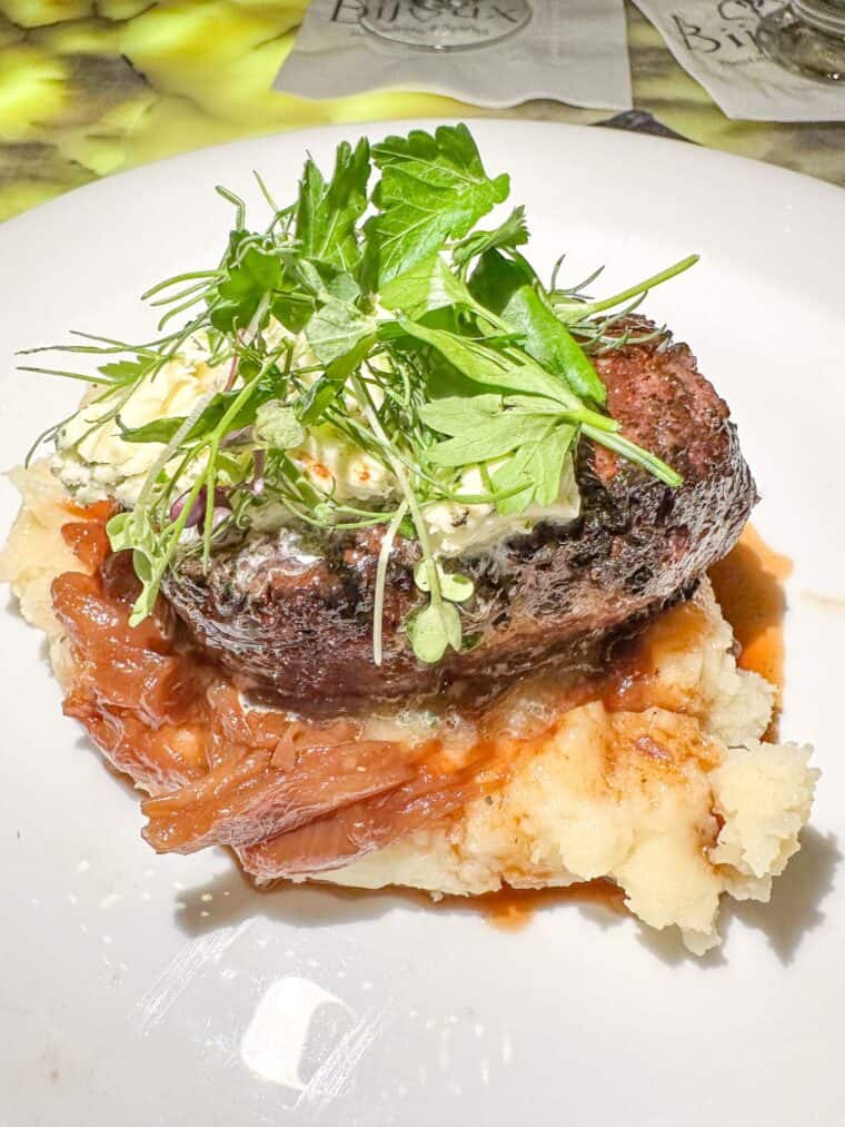 steak on top of mashed potatoes