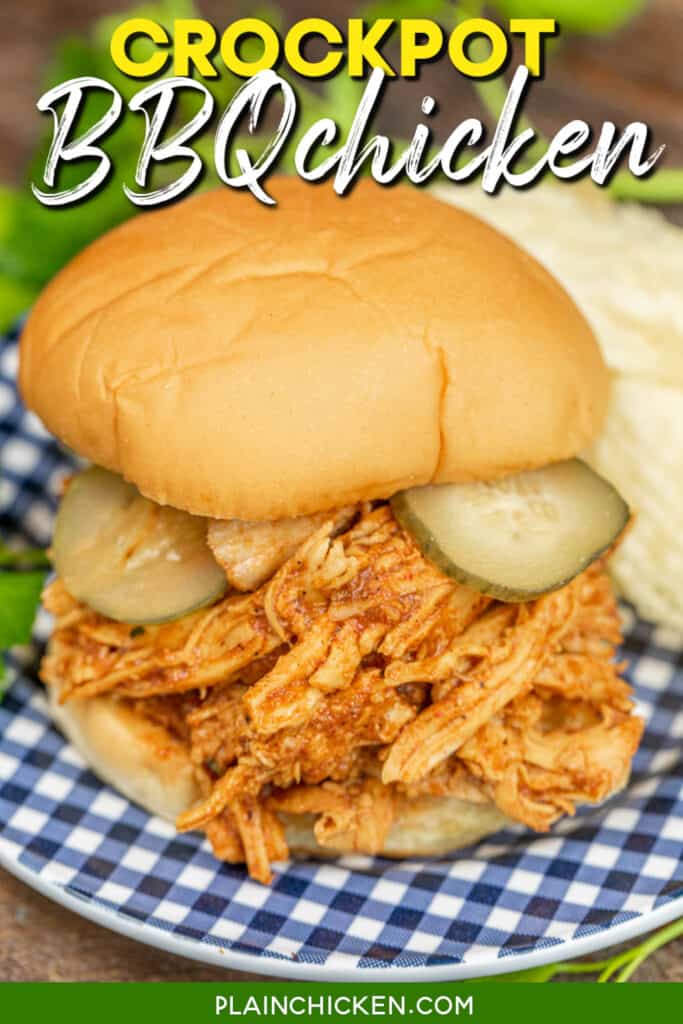 shredded bbq chicken sandwich topped with pickles on a blue checkered late with chips with text overlay