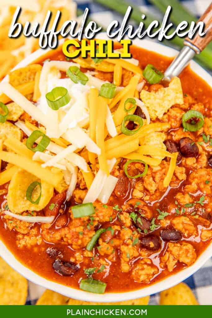 bowl of chicken chili topped with sour cream, cheese, and green onions with text overlay