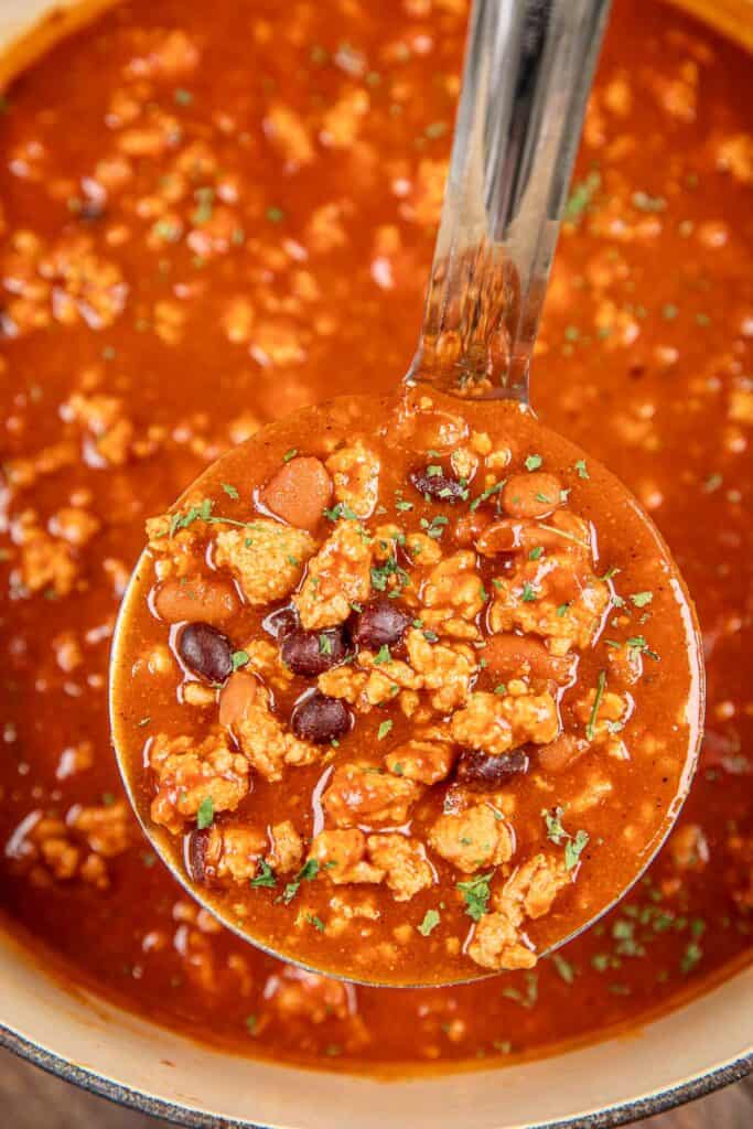 ladle of buffalo chicken chili with beans