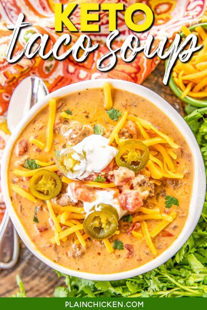 bowl of keto taco soup topped with cheese, sour cream, and jalapenos with text overlay