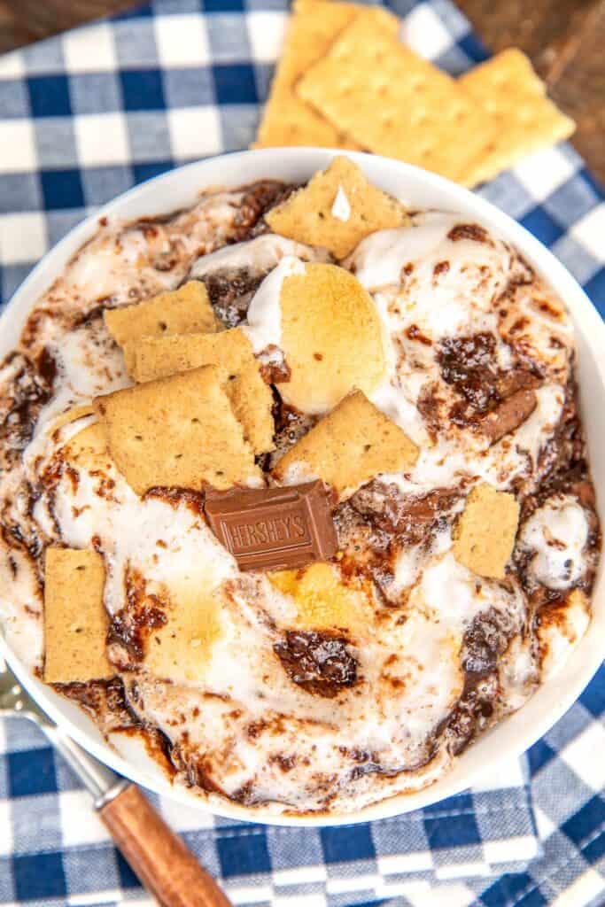 bowl of smores cake on a blue checked tablecloth