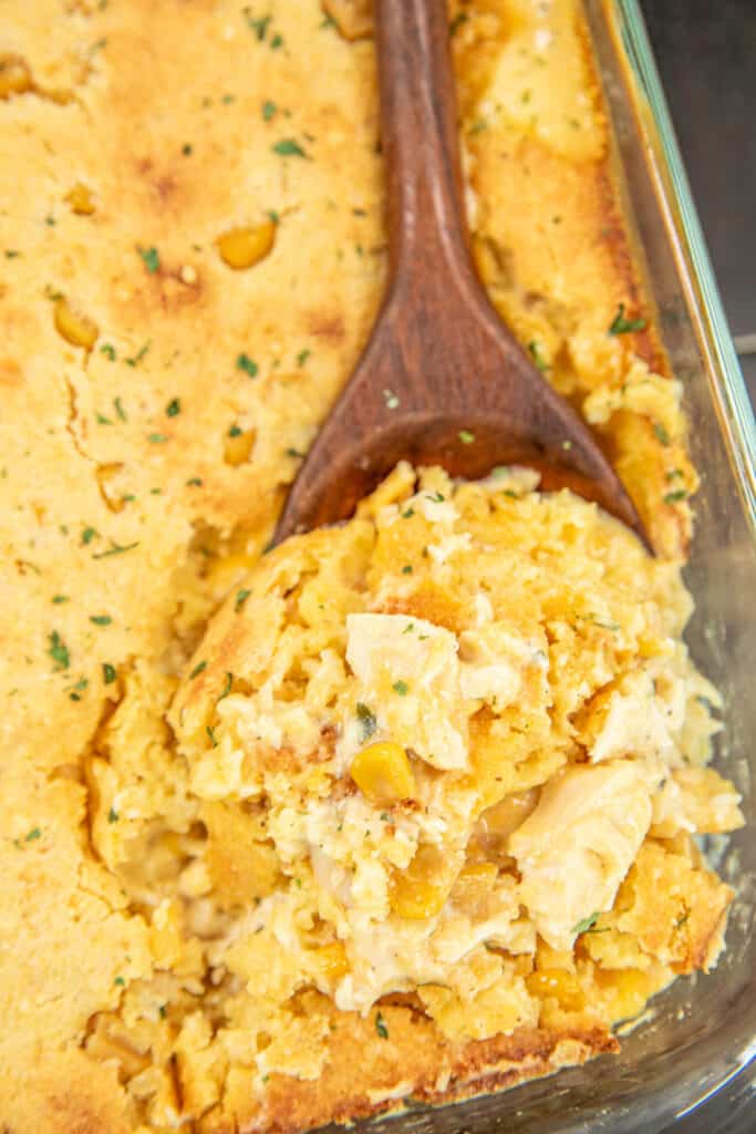 scooping chicken casserole from baking dish