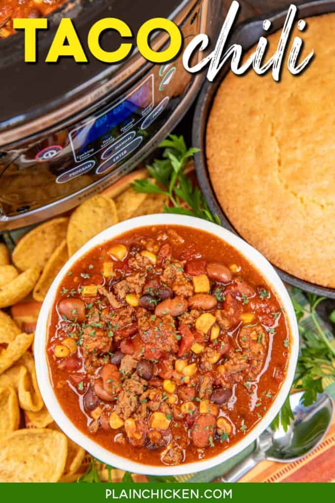 bowl of chili surrounded by fritos in front of cornbread and a crock pot with text overlay