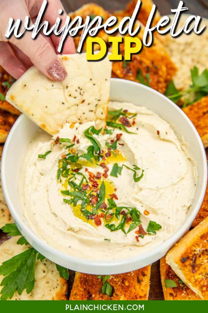 scooping whipped feta dip from a bowl onto pita bread slices with text overlay