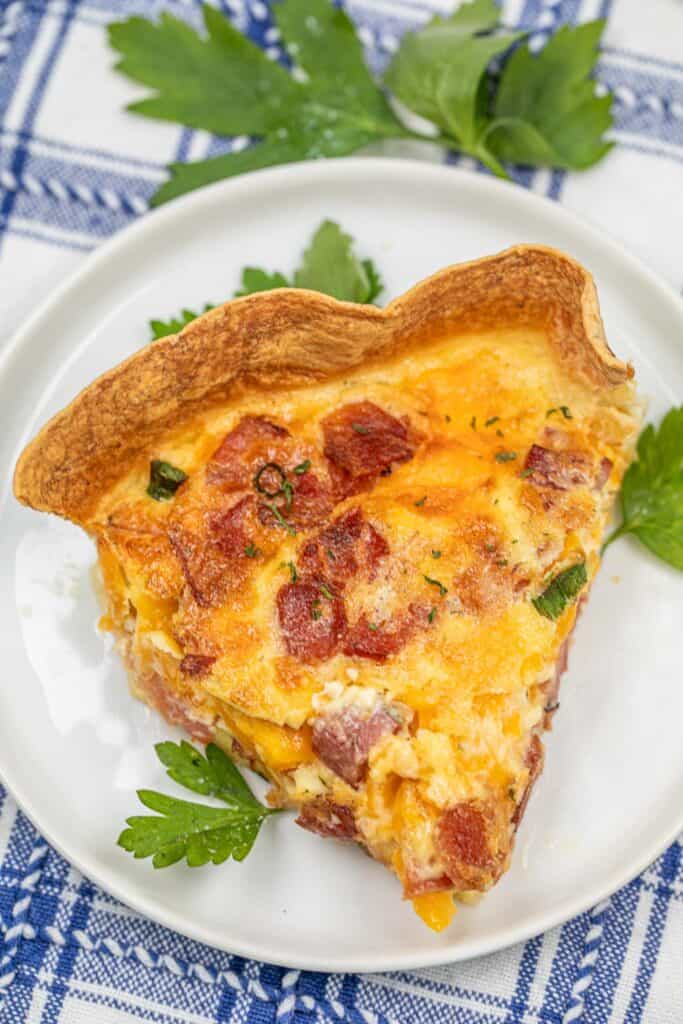 slice of bacon cheddar ranch quiche on a plate