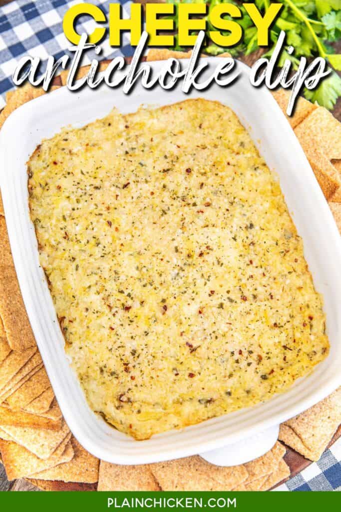 baking dish of artichoke dip surrounded by wheat thins on a table with text overlay