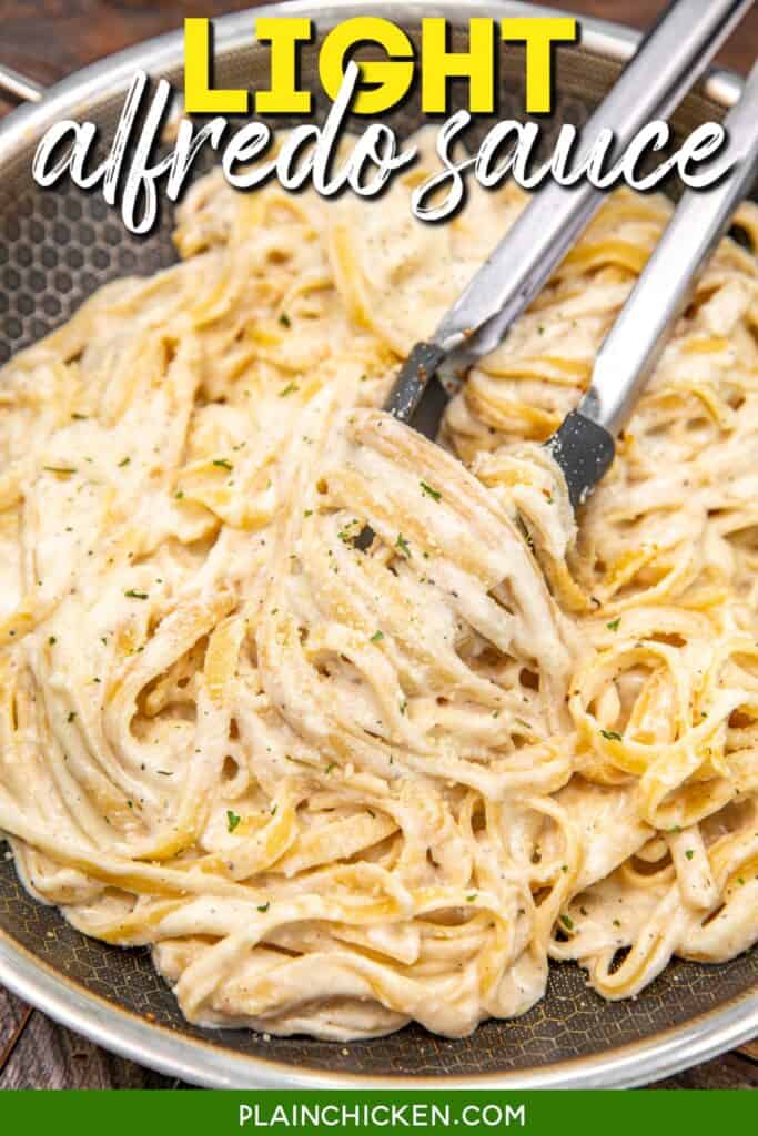 tossing fettuccine alfredo from a skillet with tongs with text overlay