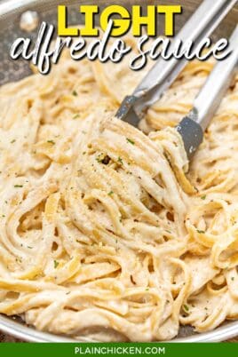 tossing fettuccine alfredo from a skillet with tongs with text overlay