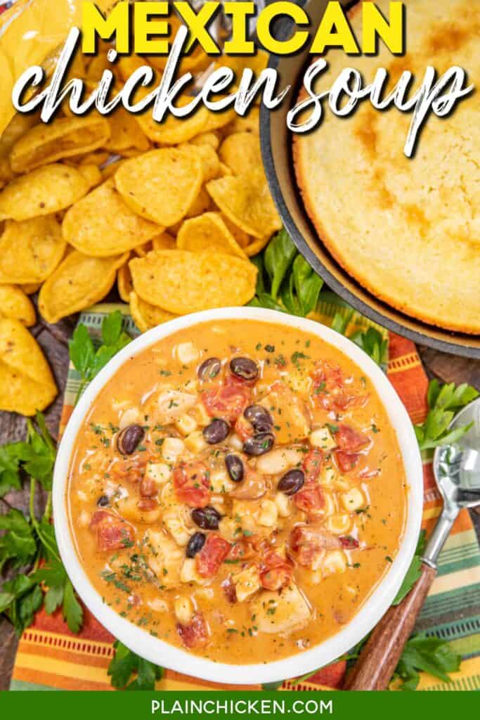bowl of cheesy mexican chicken soup on a table with fritos and cornbread with text overlay