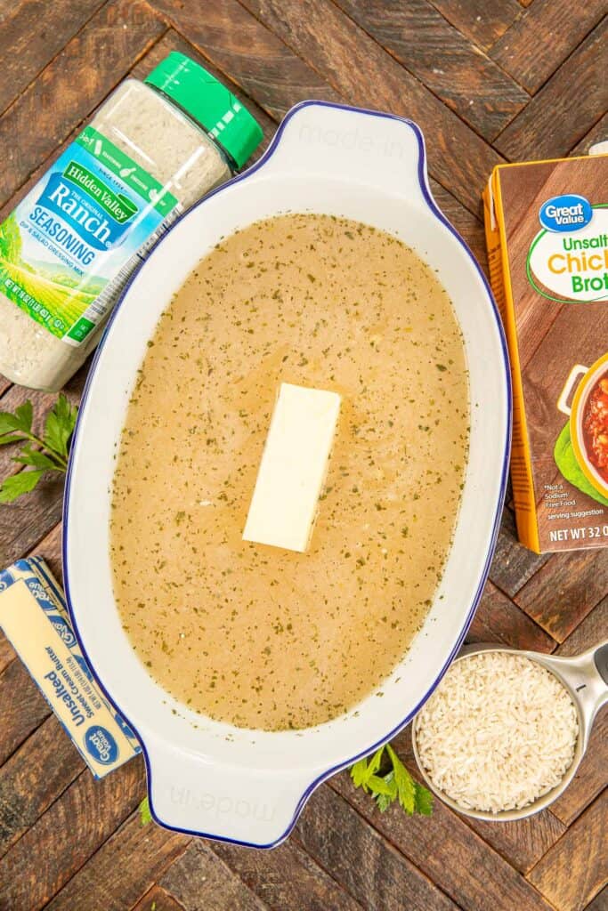 assembling ranch rice in a baking dish with ingredients around the pan