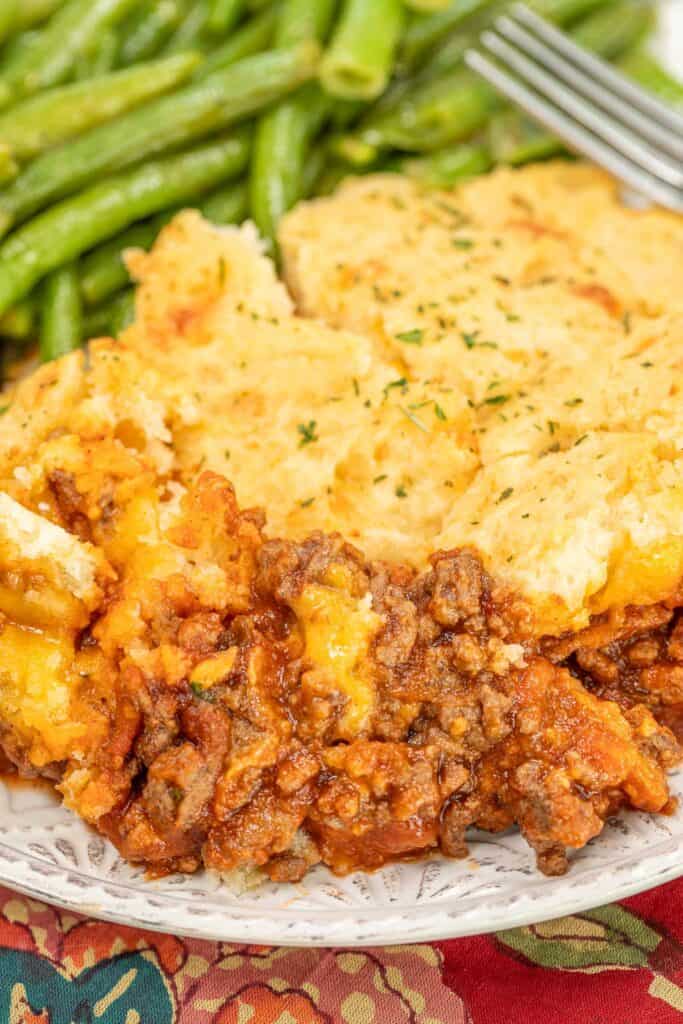 sloppy joe casserole on a plate with green beans