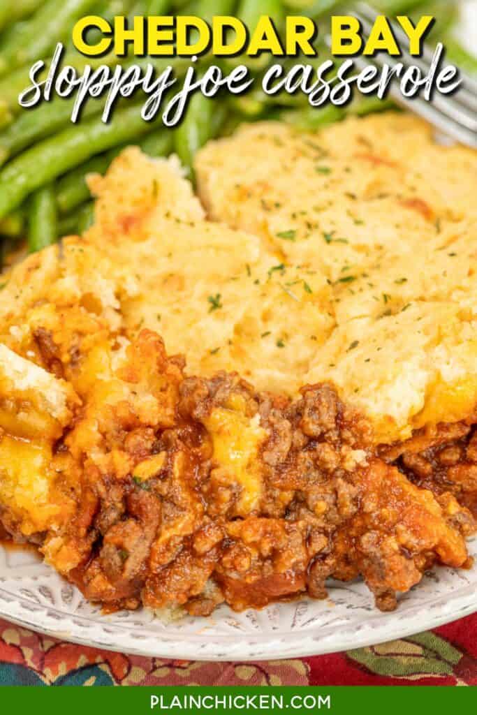 sloppy joe casserole on a plate with green beans with text overlay