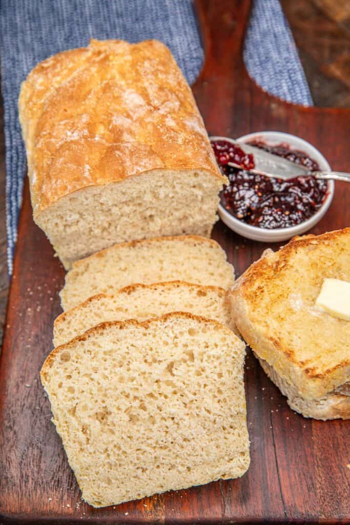 sliced english muffin bread on a cutting bard