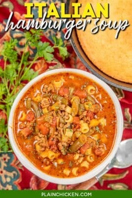 bowl of beef vegetable soup on a table with corn bread and text overlay