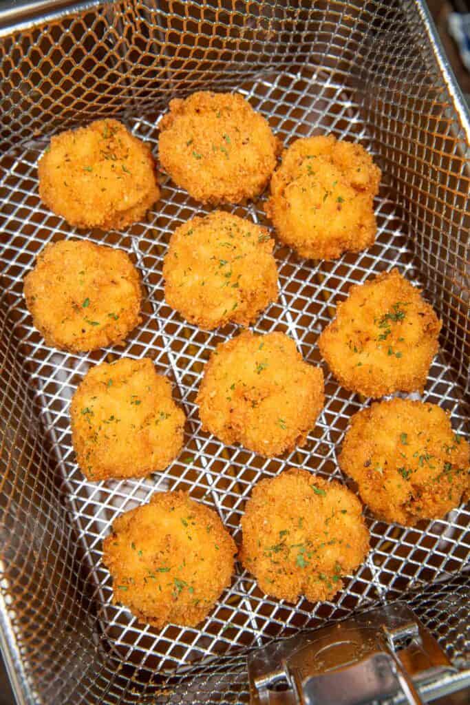 fried mac and cheese balls in a deep fryer basket