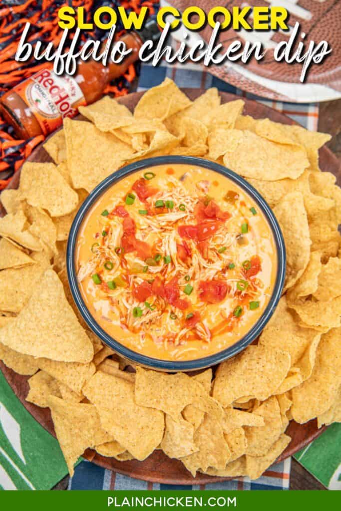bowl of buffalo chicken cheese dip surrounded by tortilla chips with text overlay
