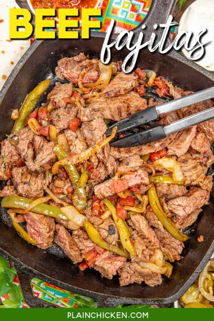 skillet of beef fajitas with tongs with text overlay
