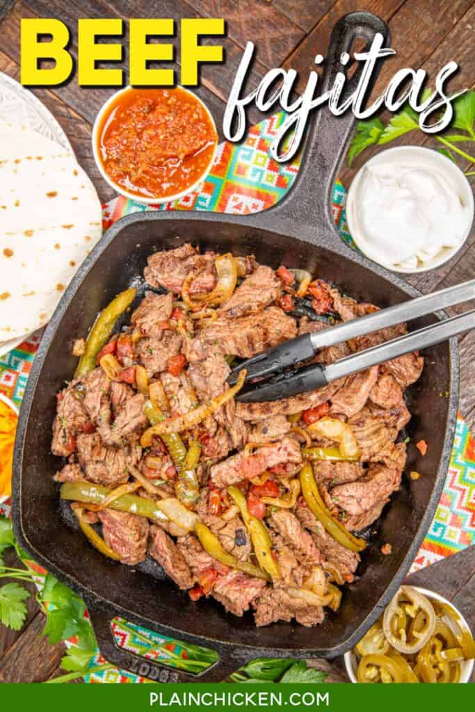 skillet of beef fajitas with tongs with text overlay