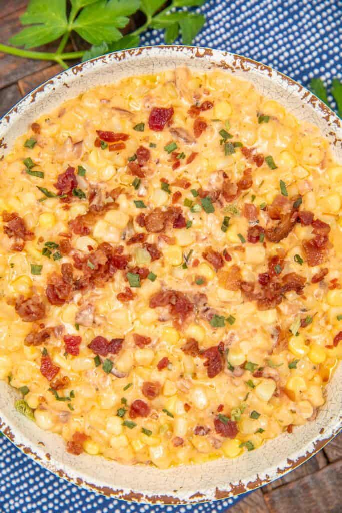 bowl of creamed corn with bacon on a table