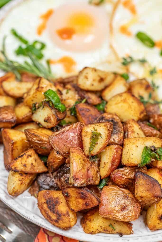 plate of home fries and fried eggs on a table